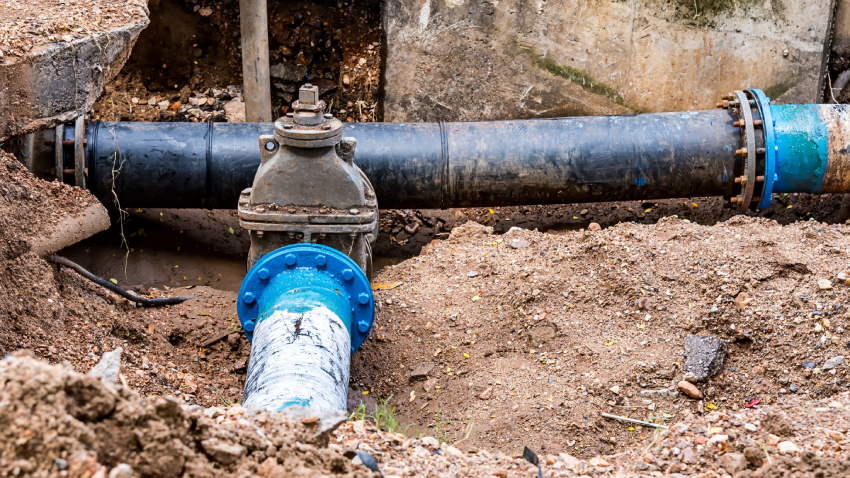 An underground water line that has been dug out and revealed with blue painted metal. An underground water line that has been dug out and revealed with blue painted metal.